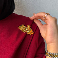 The Mokanda Golden Ribbon Brooch
